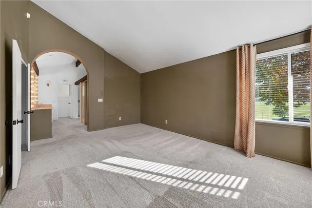 a view of a big room with windows and entryway