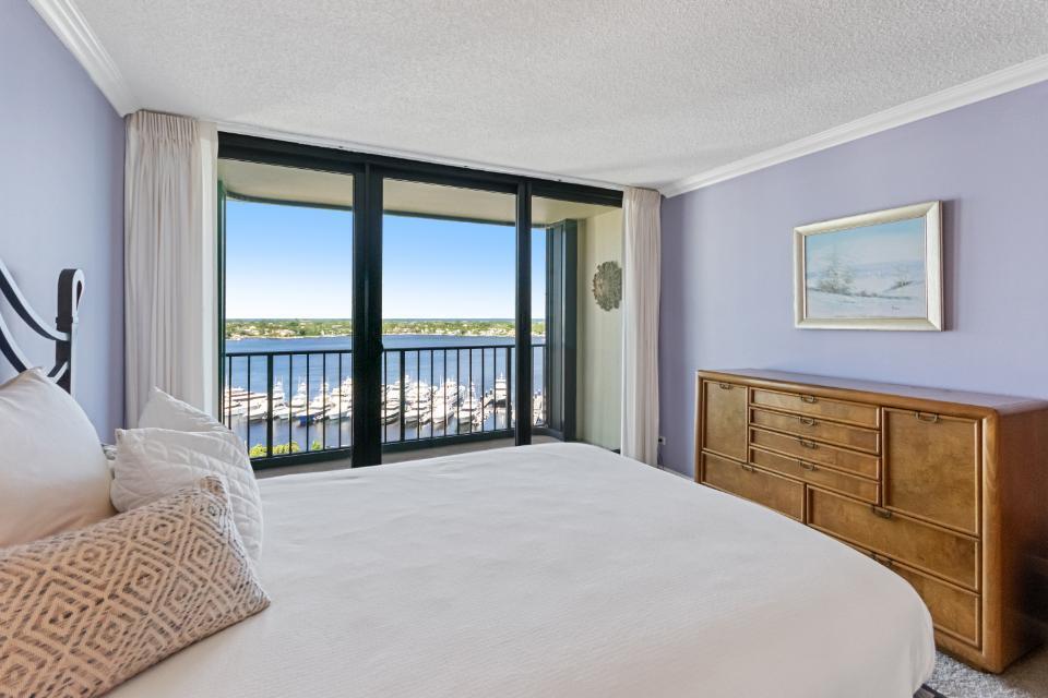 136 Lakeshore Drive, Unit PH10 North Palm Beach, FL 33408 - Photo 17 of 38 a bedroom with a bed painting and a large window