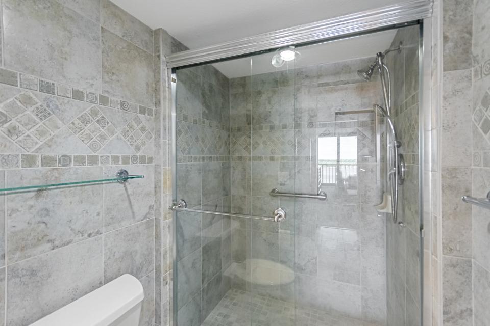 136 Lakeshore Drive, Unit PH10 North Palm Beach, FL 33408 - Photo 20 of 38 a bathroom with a shower and toilet