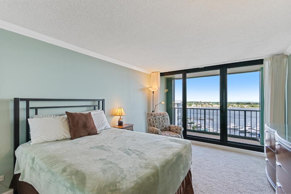 136 Lakeshore Drive, Unit PH10 North Palm Beach, FL 33408 - Photo 23 of 38 a bedroom with a large bed and a large window