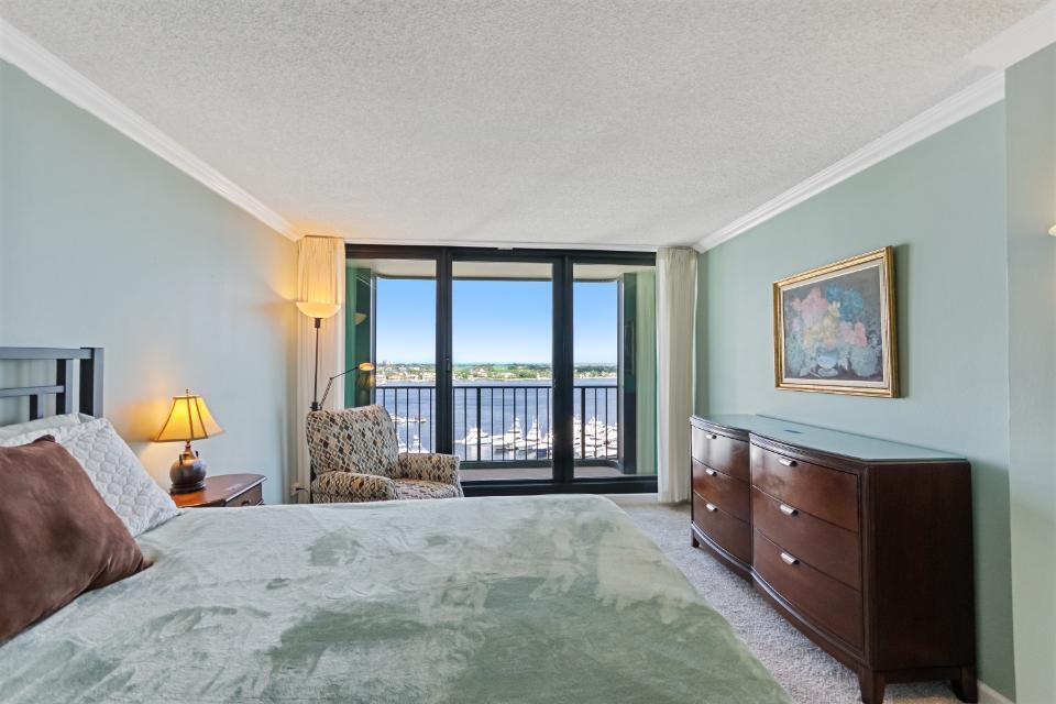 136 Lakeshore Drive, Unit PH10 North Palm Beach, FL 33408 - Photo 25 of 38 a spacious bedroom with a bed and glass windows