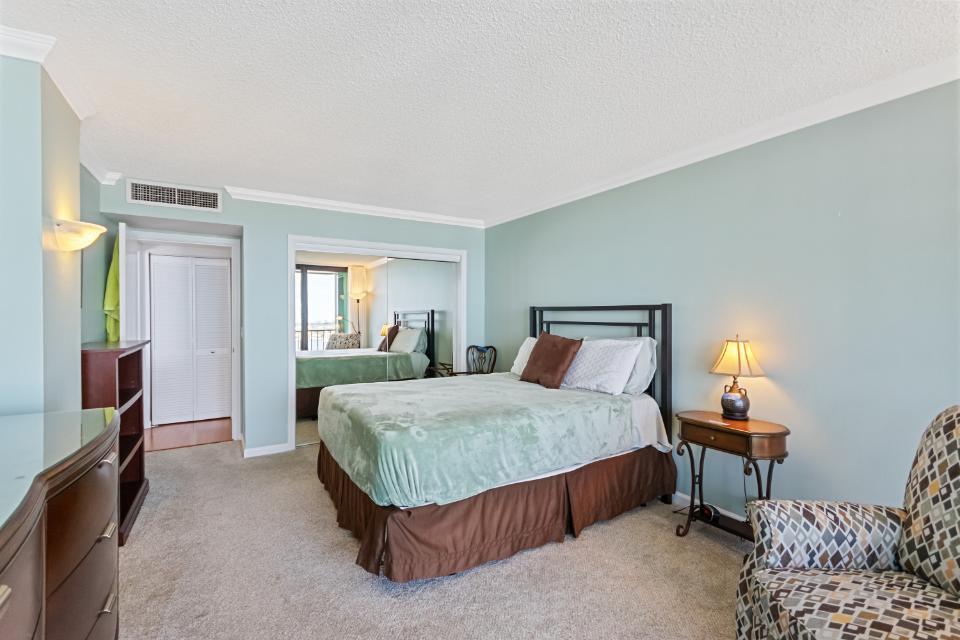 136 Lakeshore Drive, Unit PH10 North Palm Beach, FL 33408 - Photo 26 of 38 a spacious bedroom with a bed and wooden floor