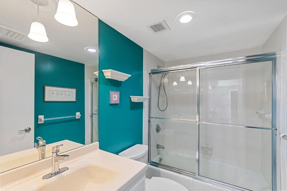 136 Lakeshore Drive, Unit PH10 North Palm Beach, FL 33408 - Photo 27 of 38 a bathroom with a sink a toilet and shower