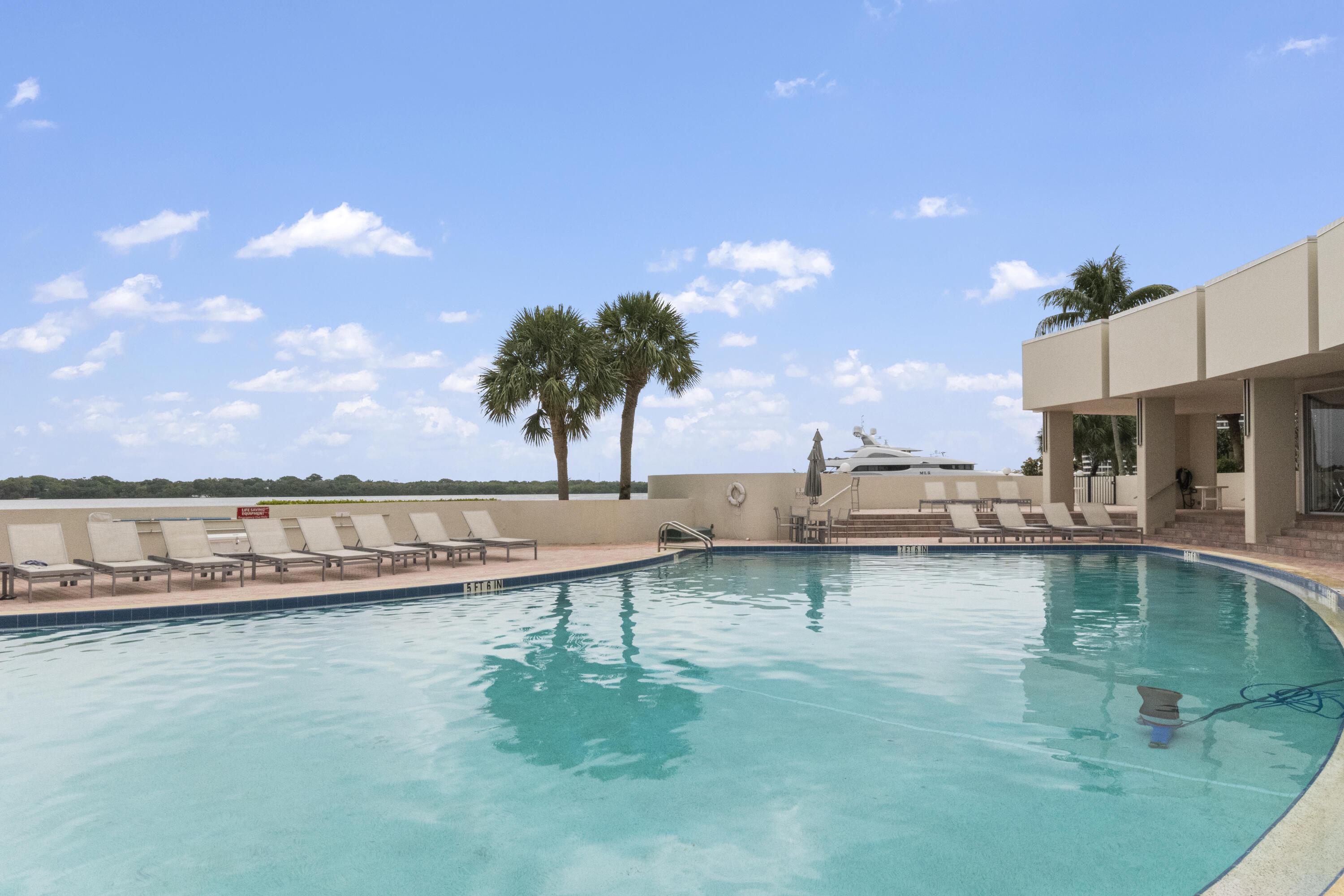136 Lakeshore Drive, Unit PH10 North Palm Beach, FL 33408 - Photo 29 of 38 a view of a lake with a house and a yard