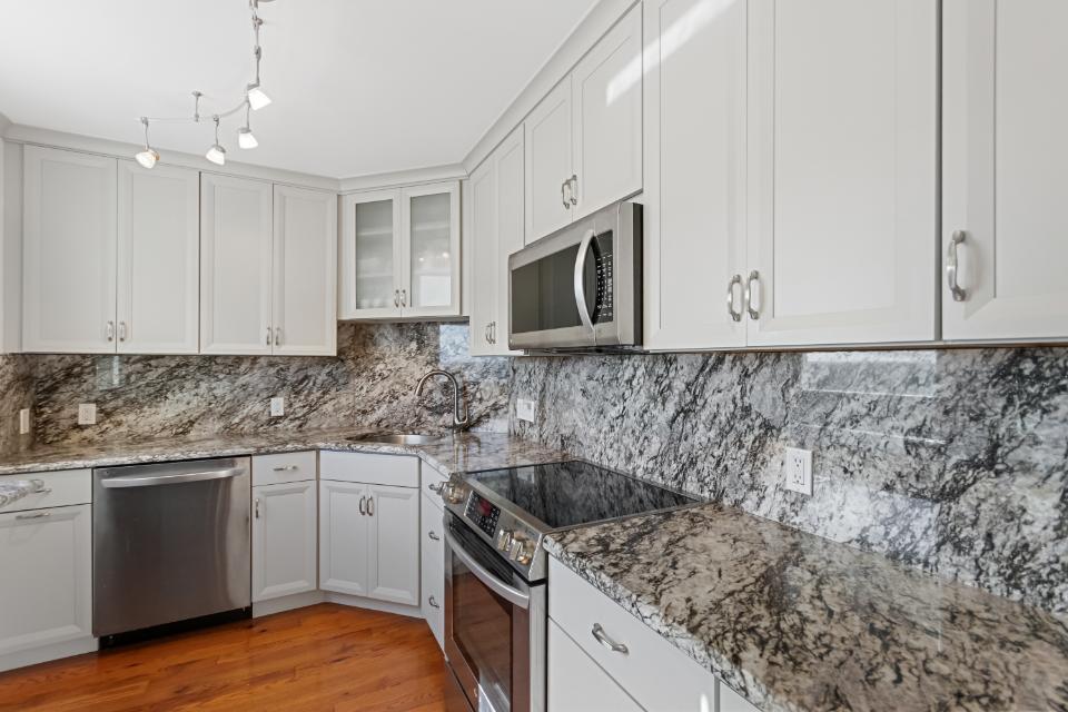 136 Lakeshore Drive, Unit PH10 North Palm Beach, FL 33408 - Photo 4 of 38 a kitchen with sink cabinets and microwave