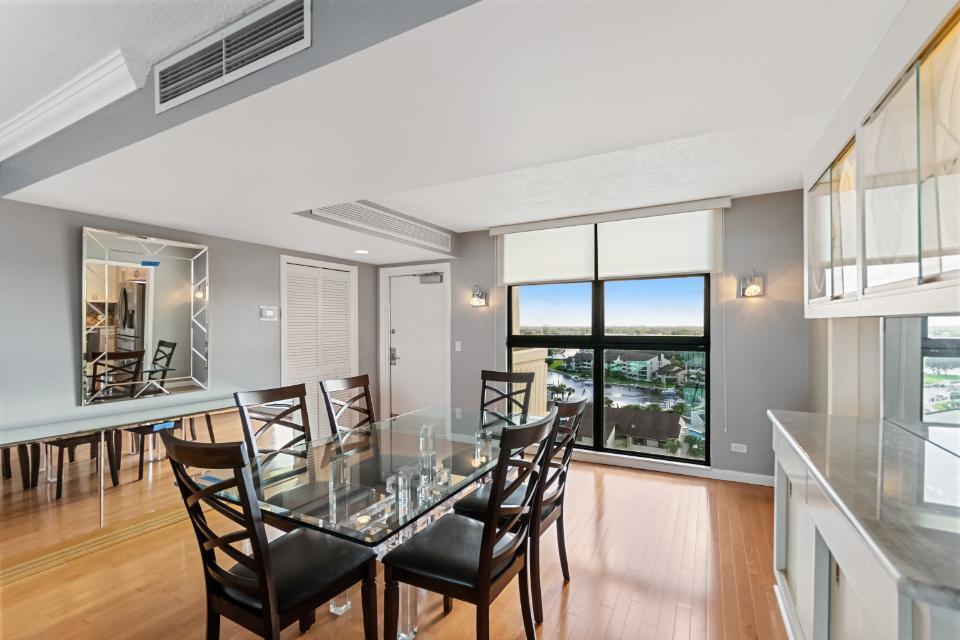 136 Lakeshore Drive, Unit PH10 North Palm Beach, FL 33408 - Photo 8 of 38 a view of a dining room with furniture window and wooden floor