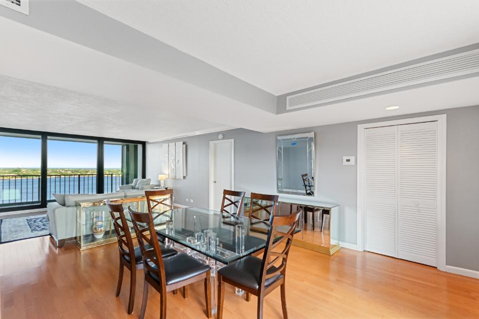 136 Lakeshore Drive, Unit PH10 North Palm Beach, FL 33408 - Photo 9 of 38 a view of a dining room with furniture window and wooden floor