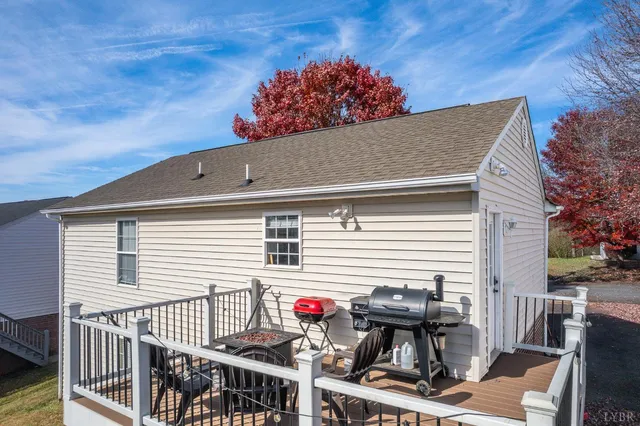 a view of a patio with table and chairs with wooden fence