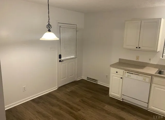 a view of a storage and utility room with wooden floor