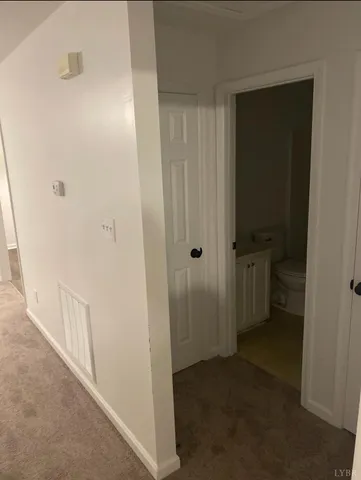 a view of a bathroom from a hallway