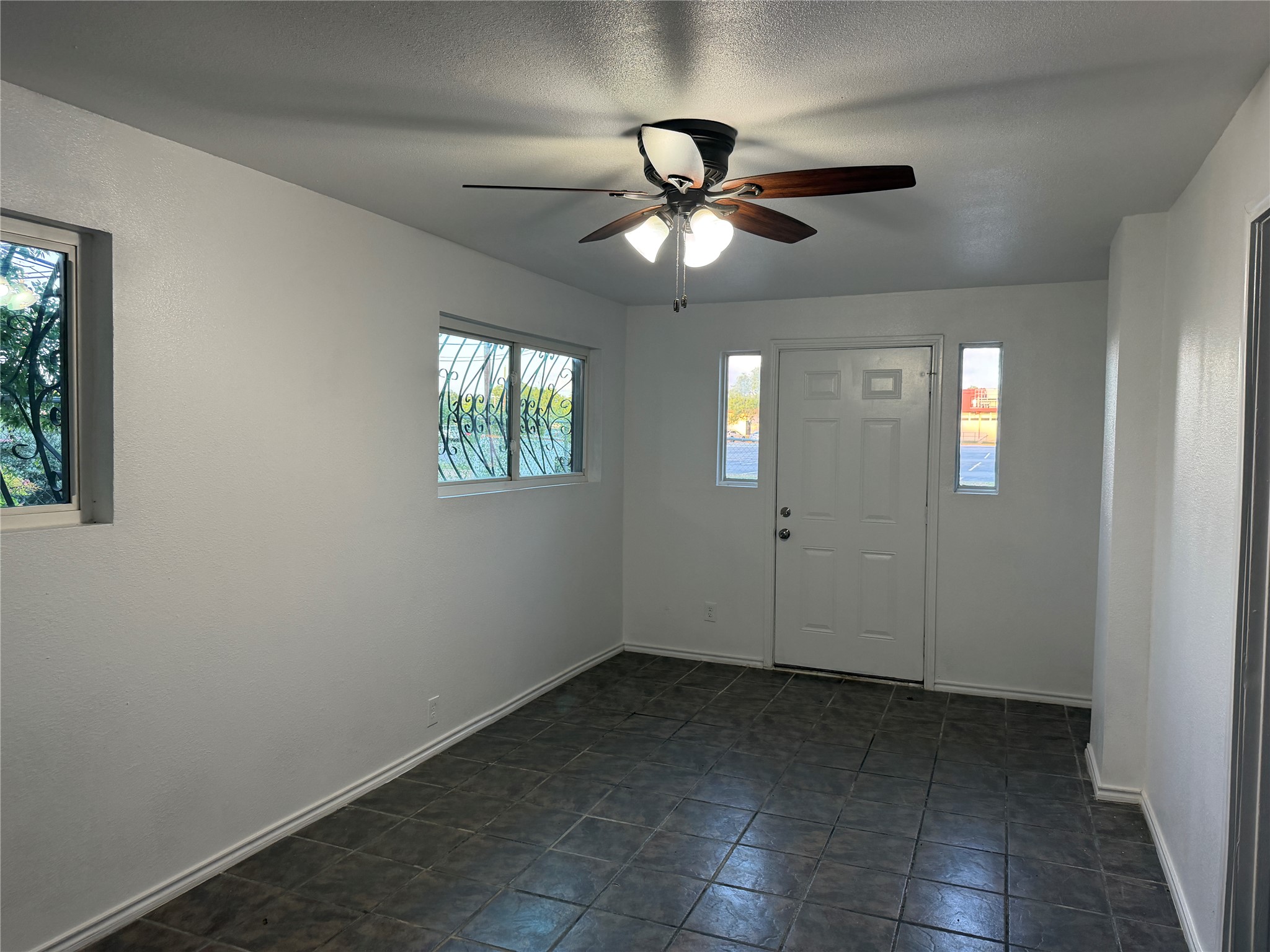 1060 Gardner Road Austin, TX 78721 - Photo 8 of 19 A welcoming entry space with a cooling ceiling fan and durable tile flooring.