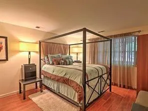 a bed sitting in a bedroom next to a window