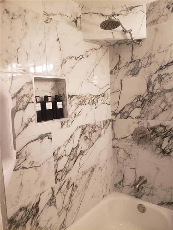 843 Artwood Road Northeast, Unit 843 Atlanta, GA 30307 - Photo 12 of 18 a bathroom with a sink and shower