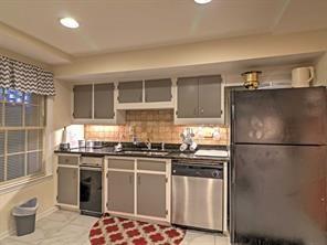 843 Artwood Road Northeast, Unit 843 Atlanta, GA 30307 - Photo 5 of 18 a kitchen with stainless steel appliances granite countertop a refrigerator and a stove top oven