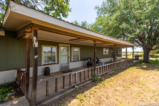 a view of a house with a wooden floor and wooden fence