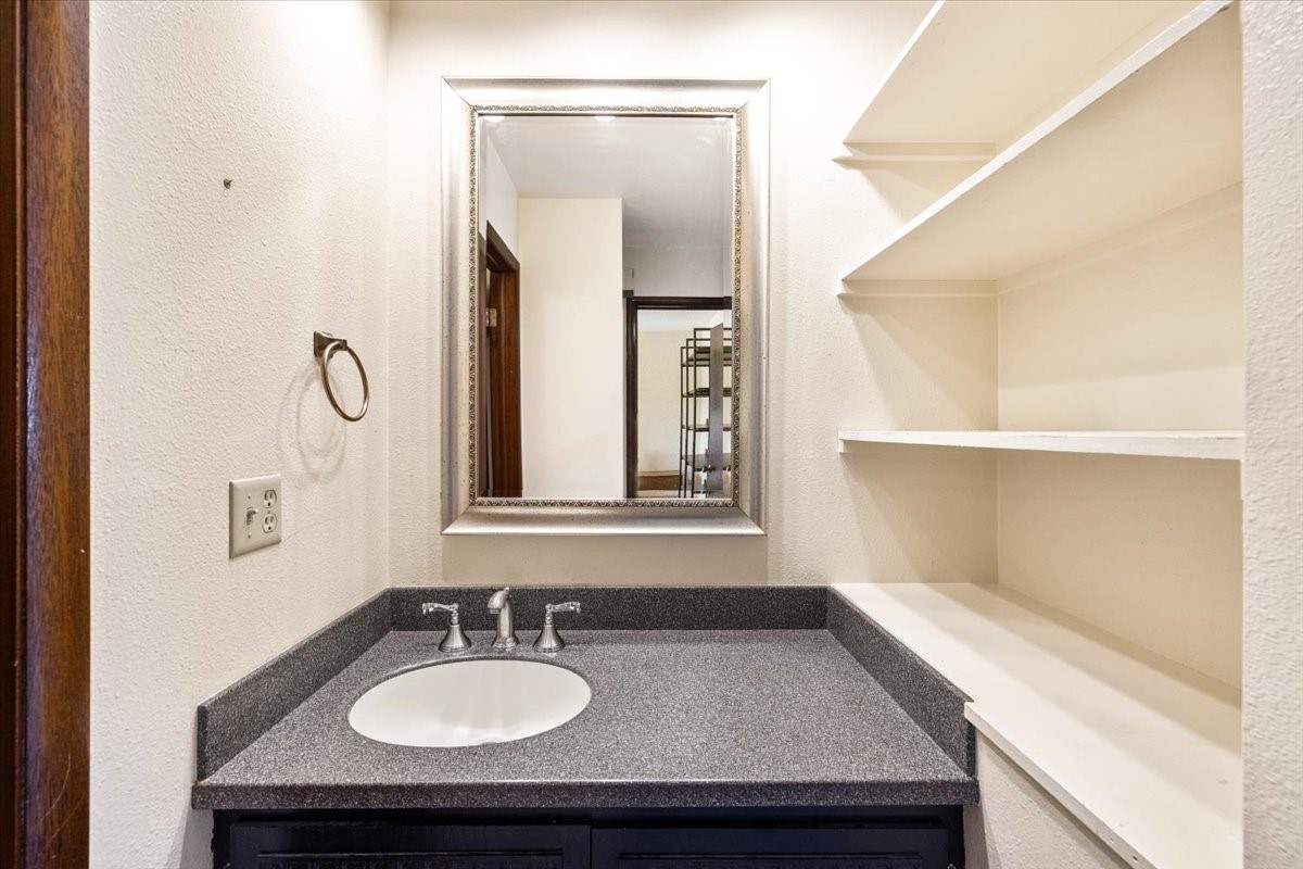 110 Evergreen Road, Unit 301 Dillon, CO 80435 - Photo 14 of 23 a bathroom with a granite countertop sink and a mirror