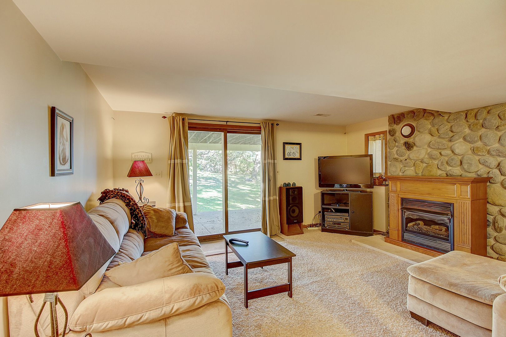 35W522 Miller Road Algonquin, IL 60102 - Photo 16 of 63 a living room with furniture a flat screen tv and a fireplace