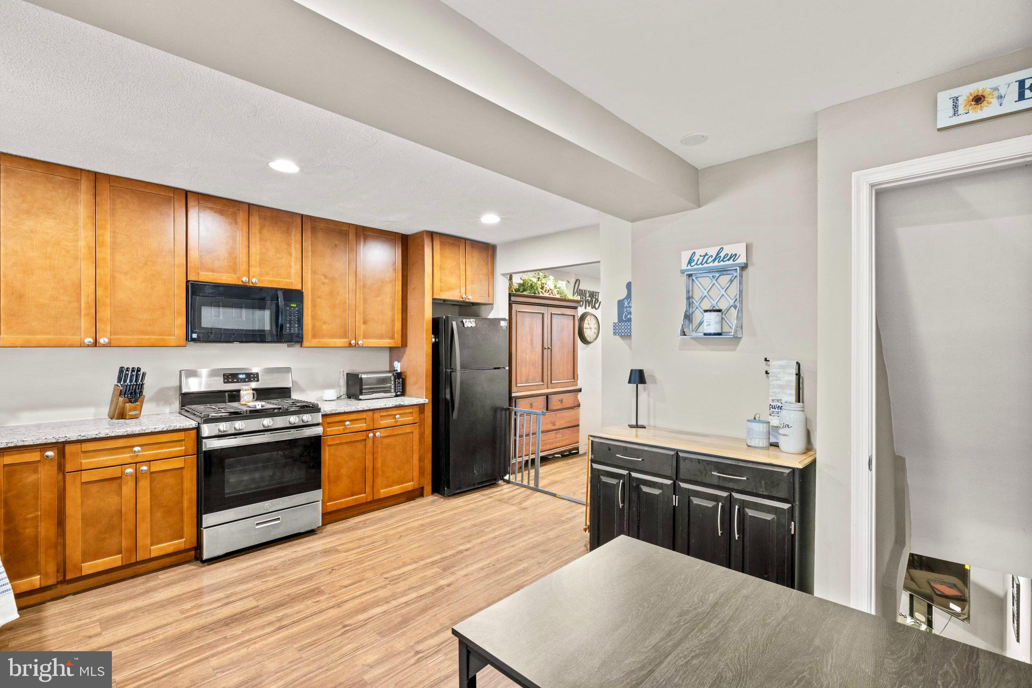 234 West Edgevale Road Baltimore, MD 21225 - Photo 5 of 45 Modern kitchen with warm wood tones.