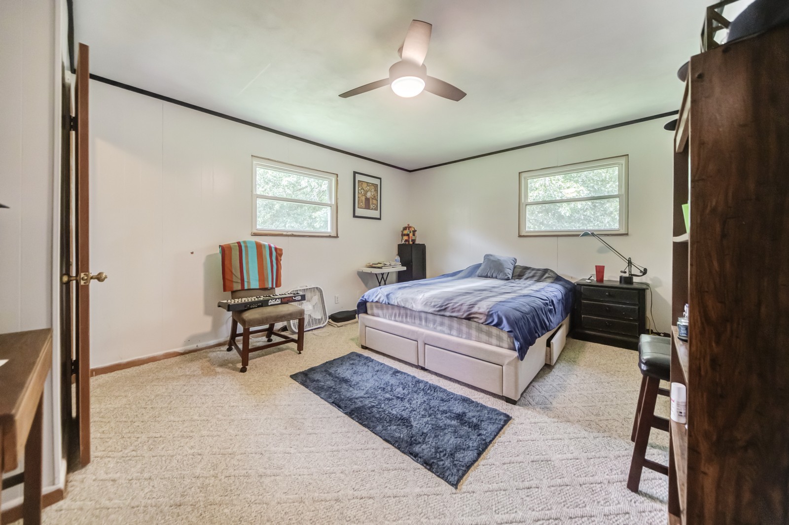 1353 Academy Road Portland, TN 37148 - Photo 19 of 35 a bedroom with a bed and a chandelier