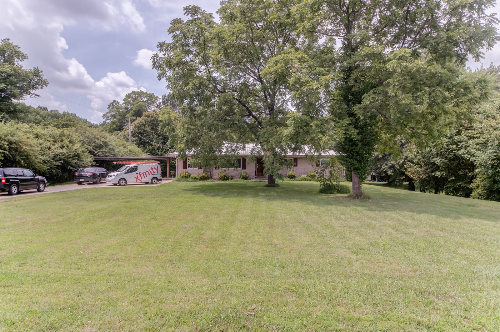 1353 Academy Road Portland, TN 37148 - Photo 32 of 35 a view of a house with a yard and garage