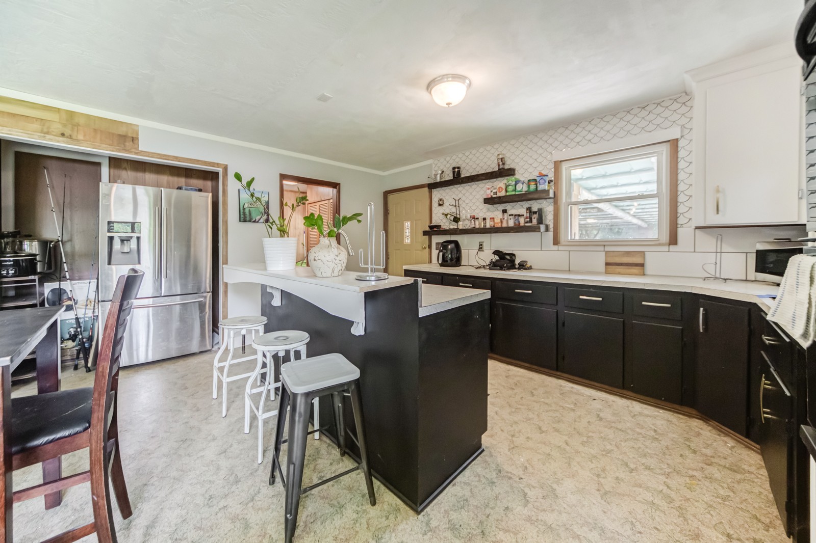 1353 Academy Road Portland, TN 37148 - Photo 5 of 35 a kitchen with a sink a stove a refrigerator and chairs