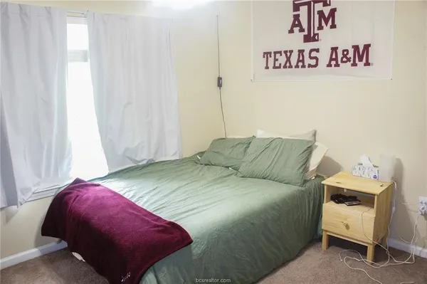 a bed room with a bed and a chair