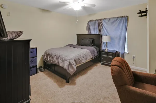 a bedroom with a bed and window