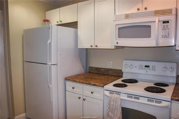 a kitchen with a stove and a refrigerator