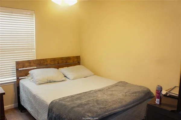 a bedroom with a bed and a table in it