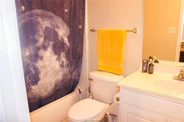 a white toilet sitting next to a bathroom sink