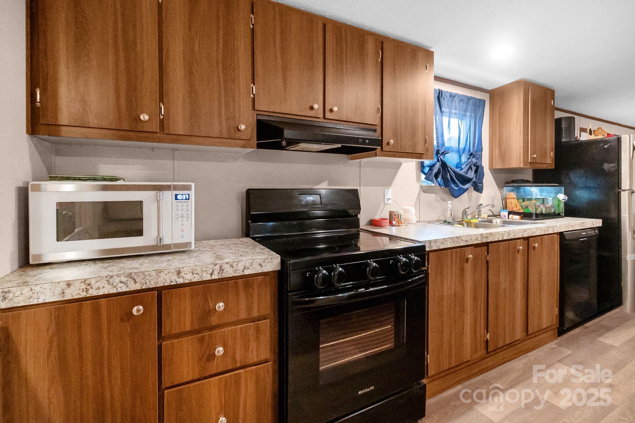 5263 Raleys Mill Road Bethune, SC 29009 - Photo 15 of 37 a kitchen with granite countertop wooden cabinets and stainless steel appliances