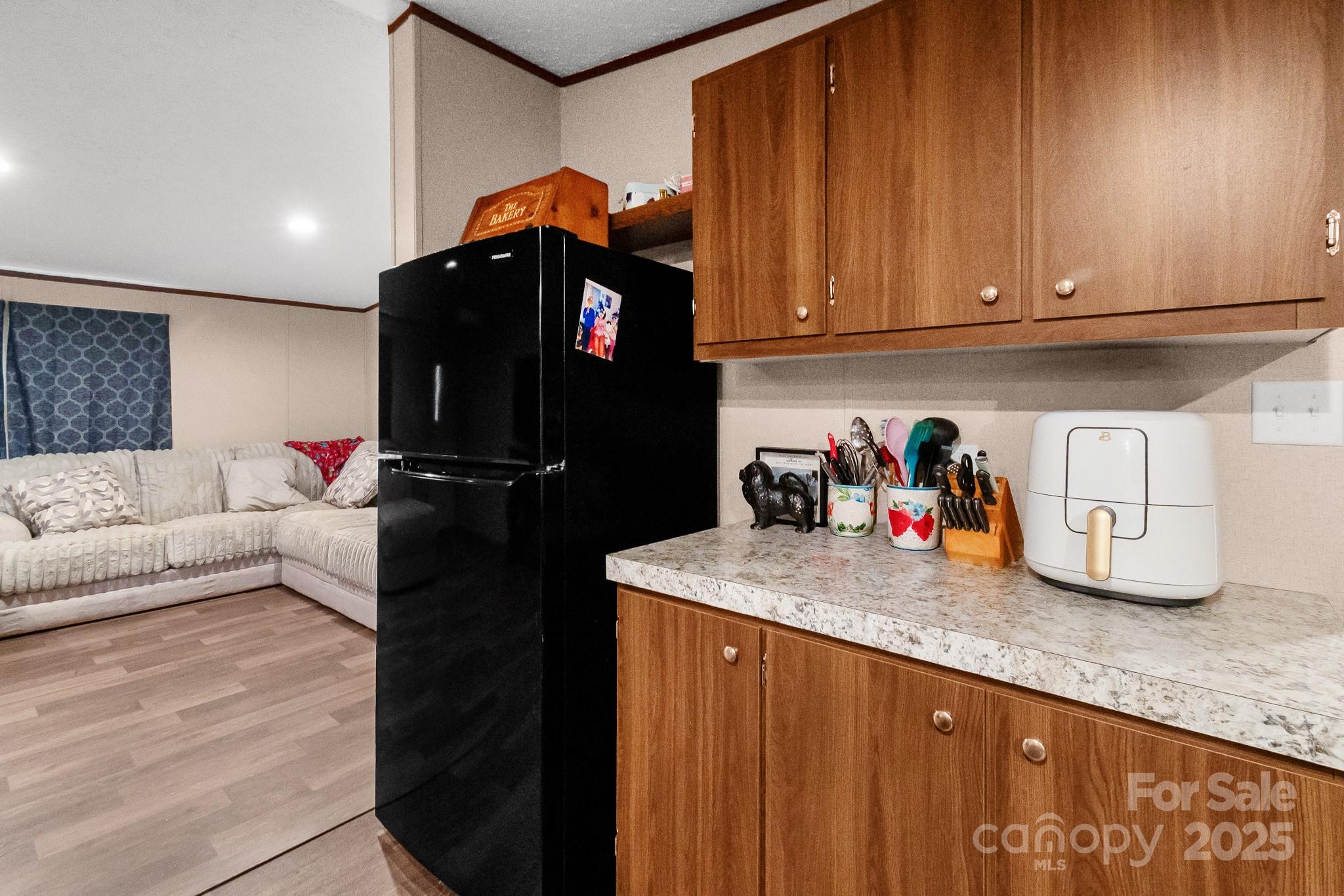 5263 Raleys Mill Road Bethune, SC 29009 - Photo 16 of 37 a kitchen with granite countertop a refrigerator and a stove top oven
