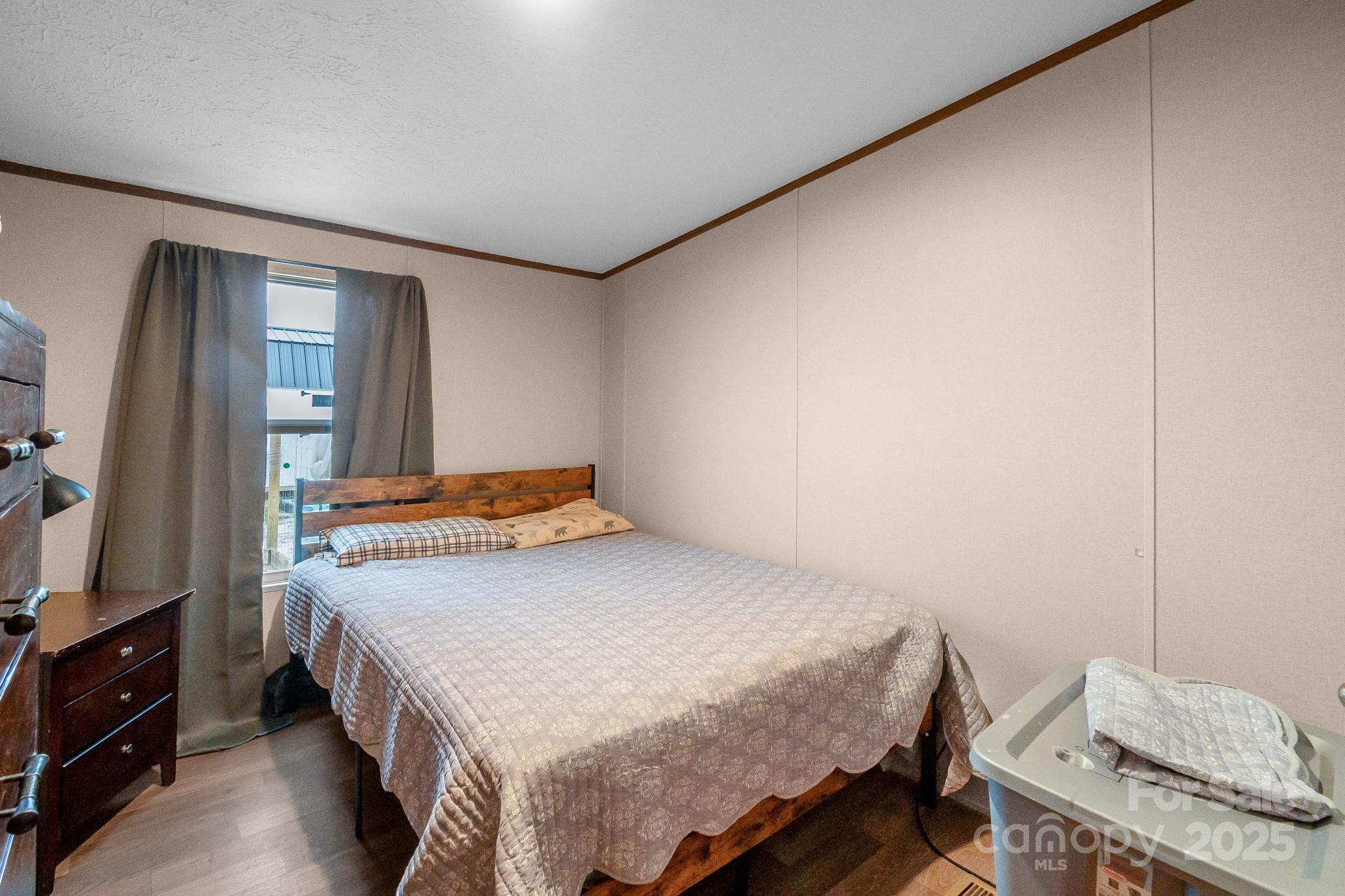 5263 Raleys Mill Road Bethune, SC 29009 - Photo 25 of 37 a bedroom with a bed and a flat tv screen on a dresser