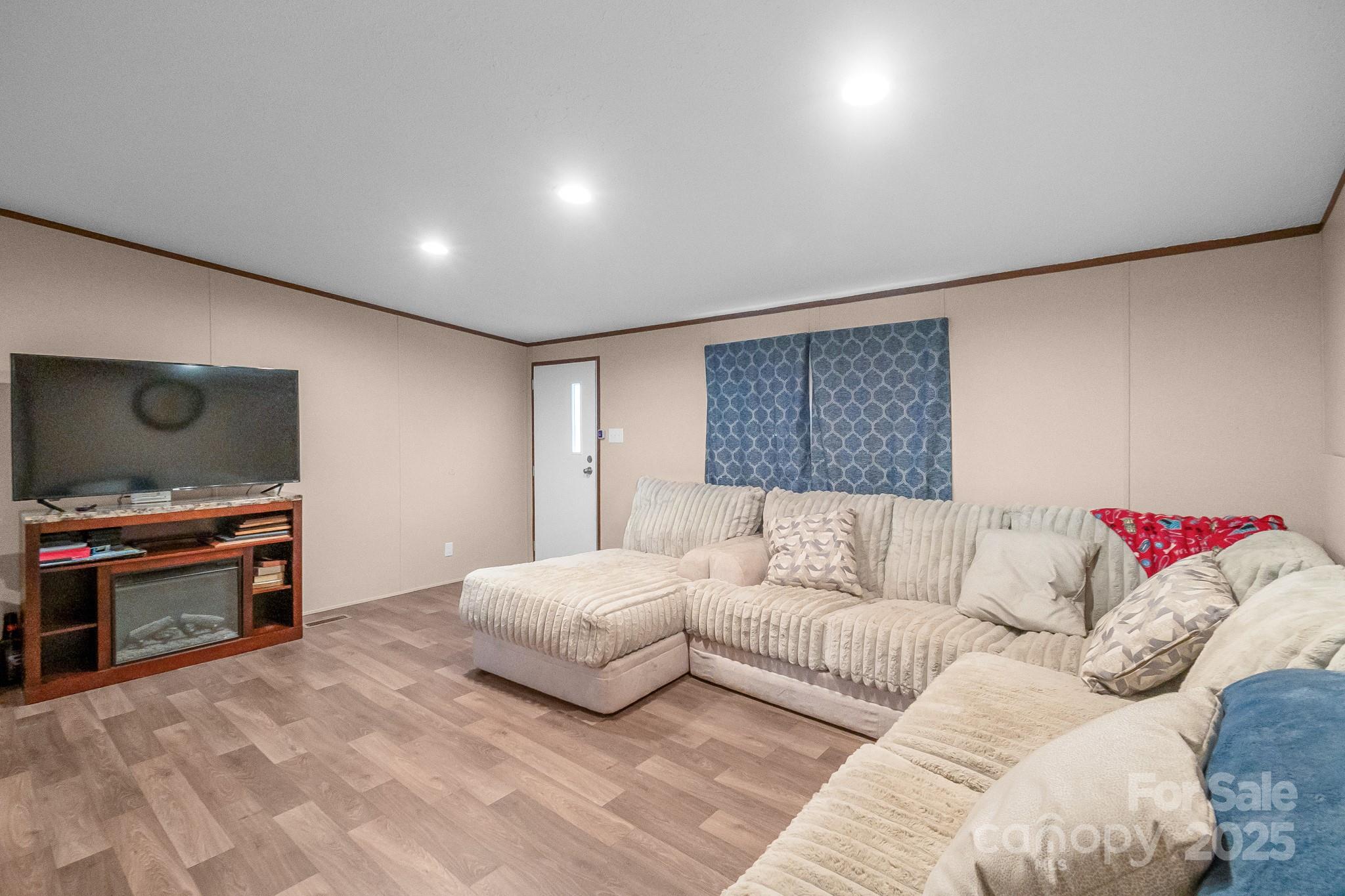 5263 Raleys Mill Road Bethune, SC 29009 - Photo 5 of 37 a spacious bedroom with a bed and a flat screen tv