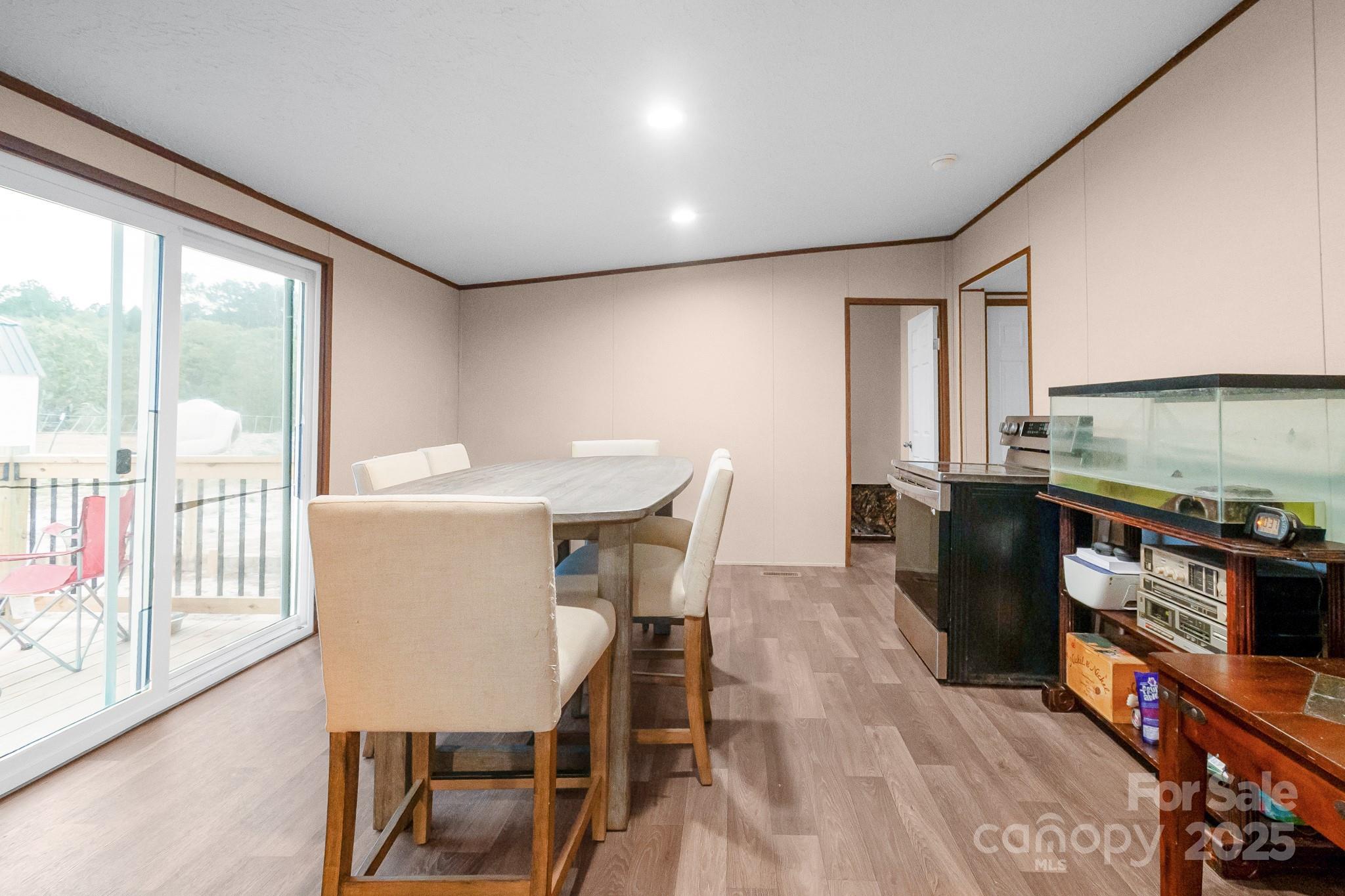5263 Raleys Mill Road Bethune, SC 29009 - Photo 7 of 37 a kitchen with stainless steel appliances kitchen island granite countertop a table chairs sink and cabinets