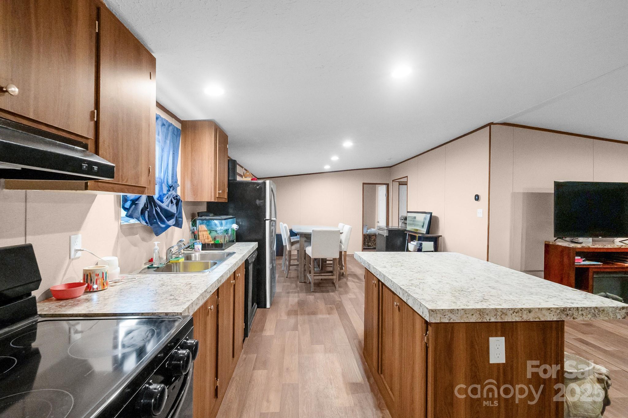 5263 Raleys Mill Road Bethune, SC 29009 - Photo 9 of 37 a kitchen with a stove a refrigerator and a dining table