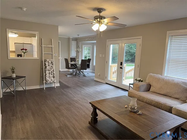 a living room with furniture and wooden floor