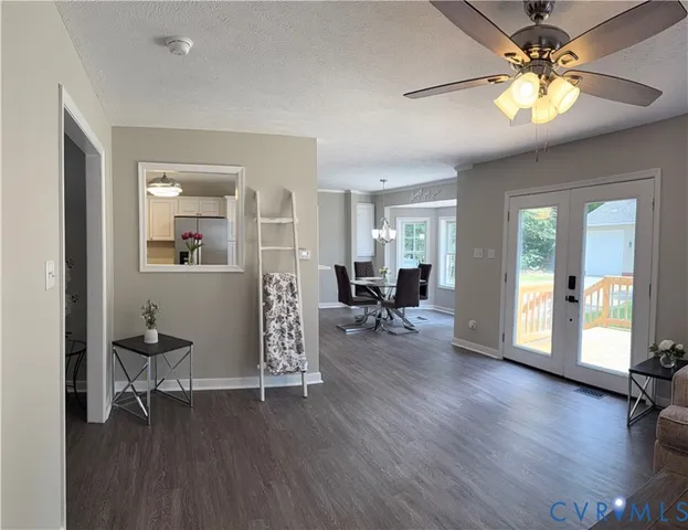 a view of a livingroom with hardwood floor and a ceiling fan