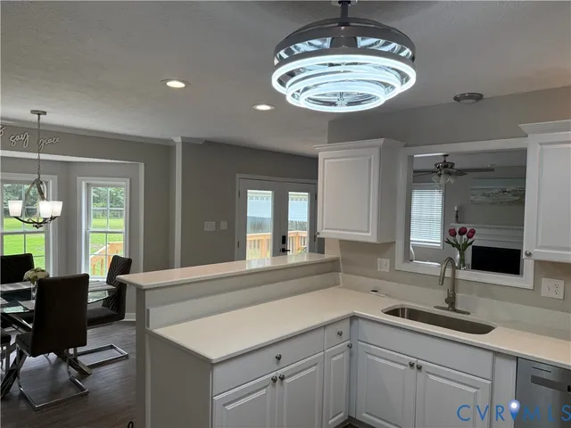 a kitchen with a sink and chandelier