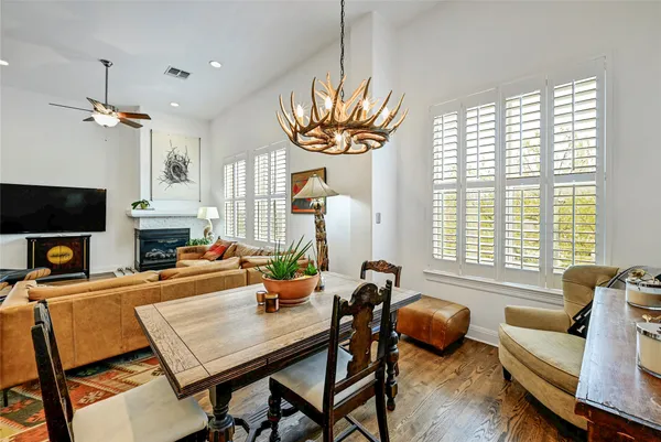 a living room with furniture a fireplace and a large window