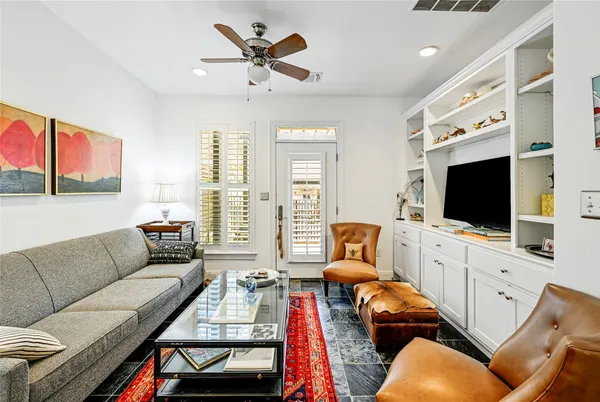 a room with furniture a flat screen tv and a window