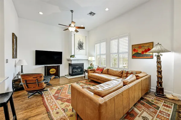 a living room with furniture ceiling fan and a window
