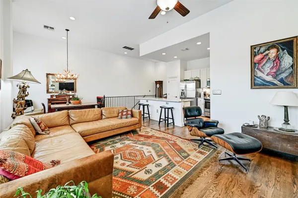 a kitchen with stainless steel appliances granite countertop a table chairs refrigerator and microwave