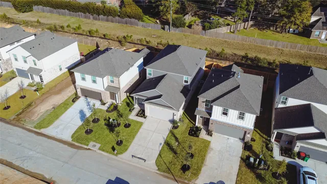 an aerial view of residential houses with outdoor space