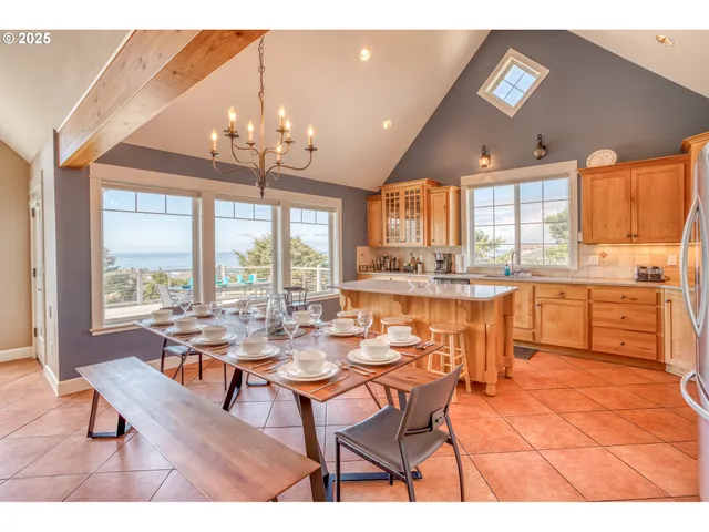 a dining hall with stainless steel appliances a table and chairs