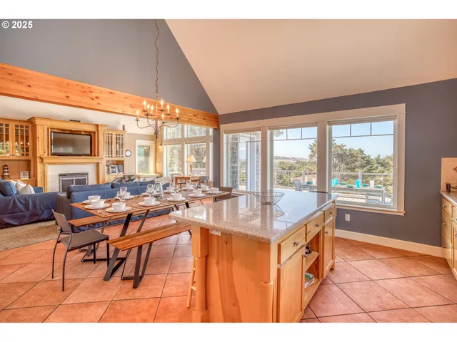 a dining room with furniture and a large window