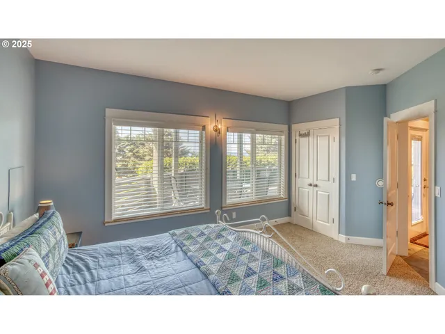 a living room with a bed furniture and next to a window