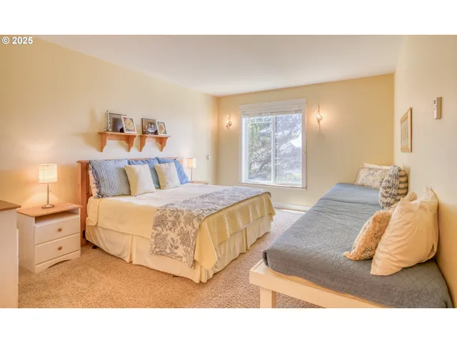 a spacious bedroom with a bed and window