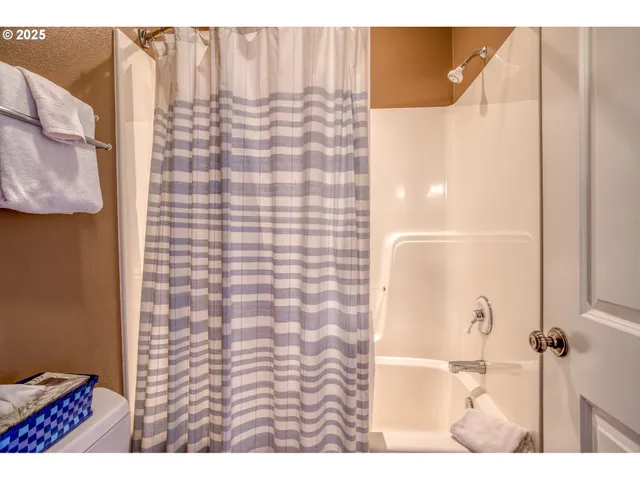 a bathroom with a shower and a sink