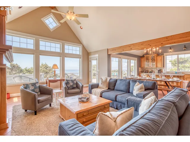 a living room with furniture city view and large windows
